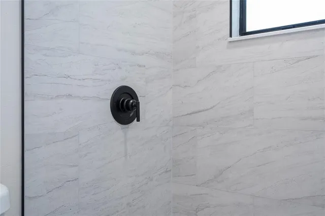 a bathroom with a sink a toilet a mirror and shower