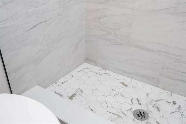 a view of kitchen with kitchen island wooden floor and stainless steel appliances
