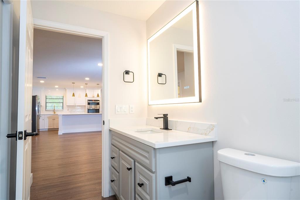 1124 Munster Street Orlando, FL 32803 - Photo 26 of 64 a bathroom with a sink a toilet a mirror and shower