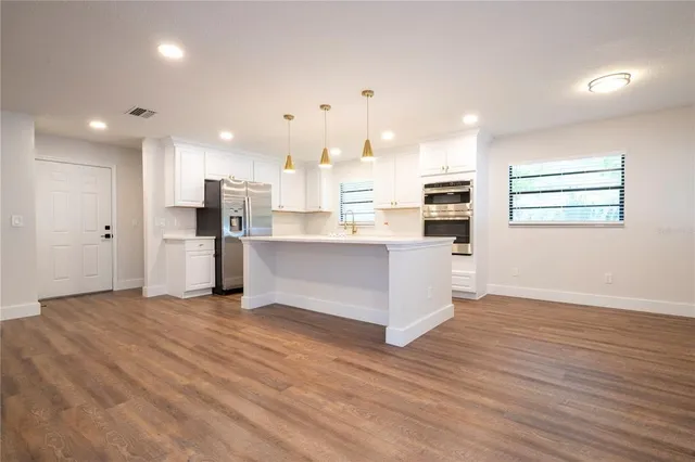 a kitchen with stainless steel appliances cabinets and a counter top space