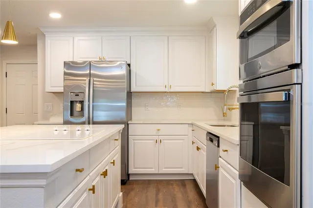a kitchen with a stove and white cabinets