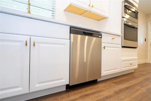 a view of a kitchen with kitchen island and stainless steel appliances
