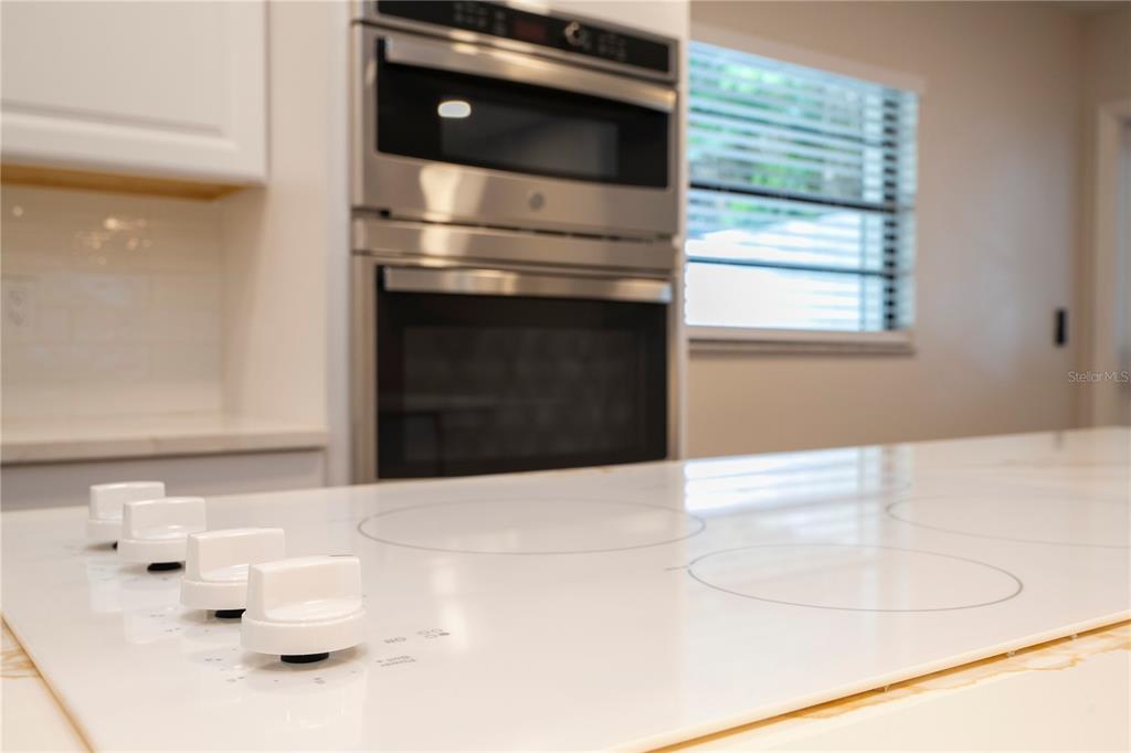 1124 Munster Street Orlando, FL 32803 - Photo 40 of 64 a kitchen with a stove and white cabinets