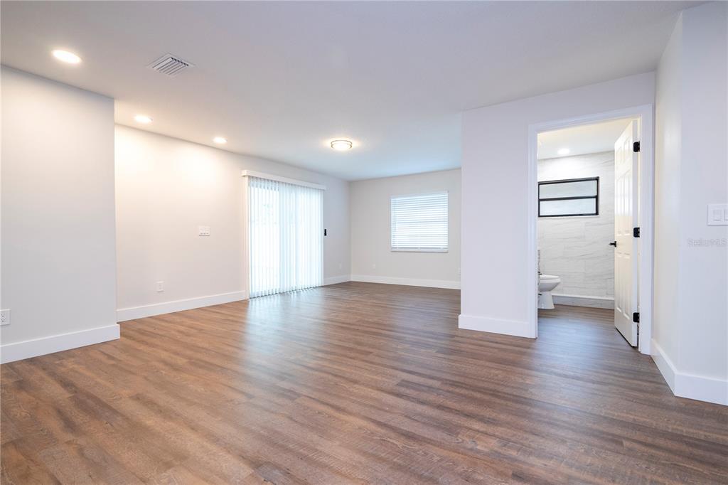 1124 Munster Street Orlando, FL 32803 - Photo 42 of 64 a view of an empty room with wooden floor and a window
