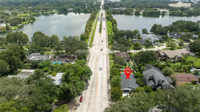an aerial view of residential house with outdoor space and lake view