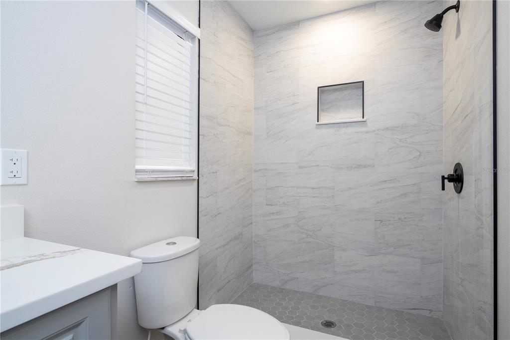 1124 Munster Street Orlando, FL 32803 - Photo 57 of 64 a white toilet sitting next to a bathroom sink