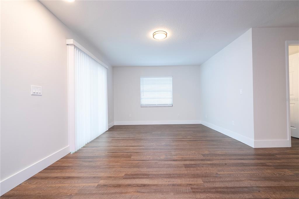 1124 Munster Street Orlando, FL 32803 - Photo 59 of 64 an empty room with wooden floor and windows