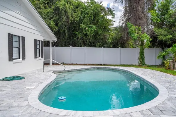 a view of a swimming pool with a patio
