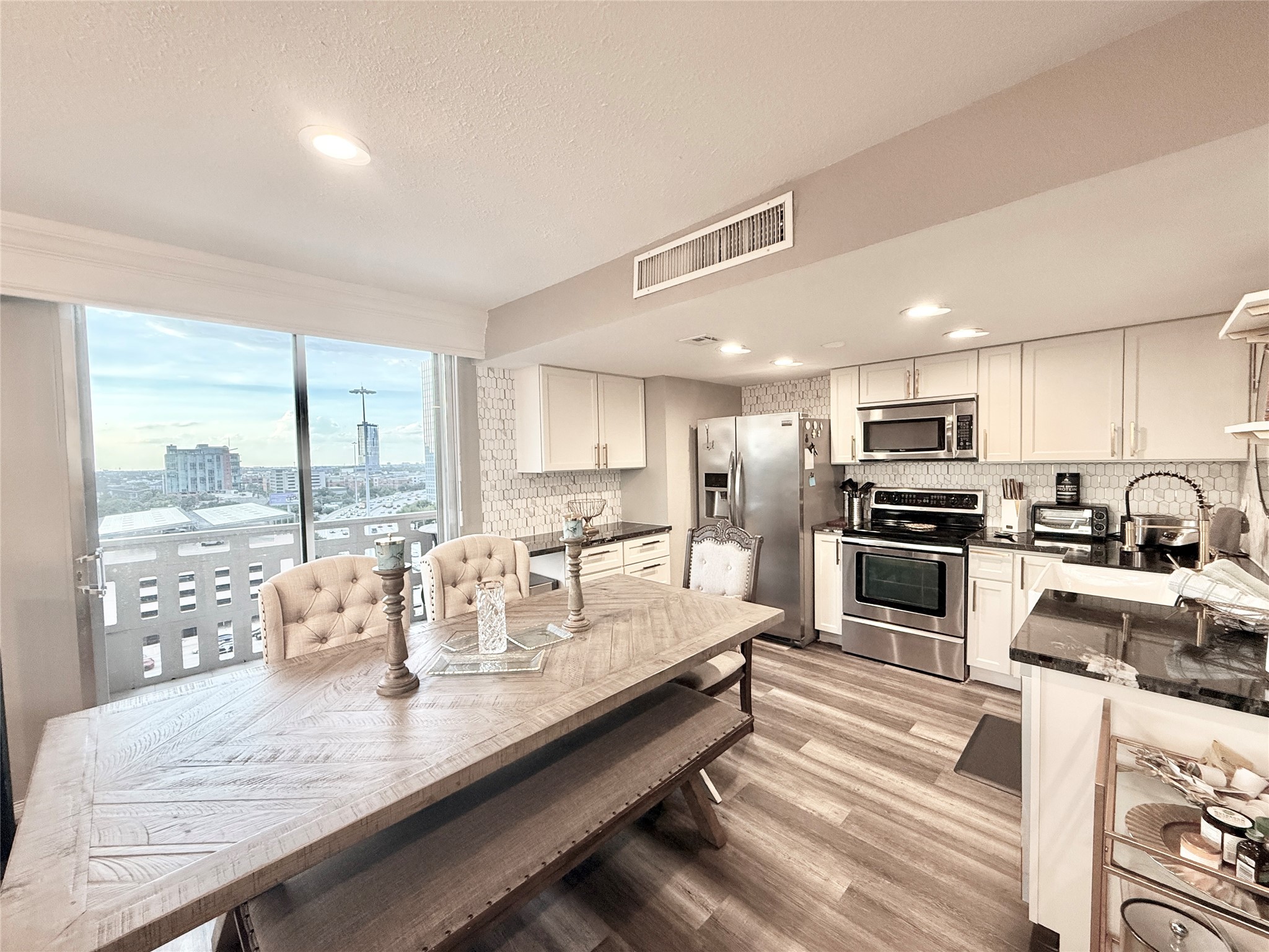 2016 Main Street, Unit 1022 Houston, TX 77002 - Photo 4 of 48 a kitchen with sink refrigerator and large window
