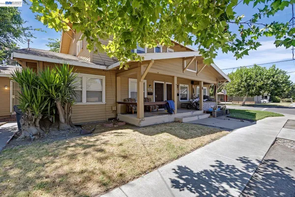 a view of a house with backyard porch and sitting area