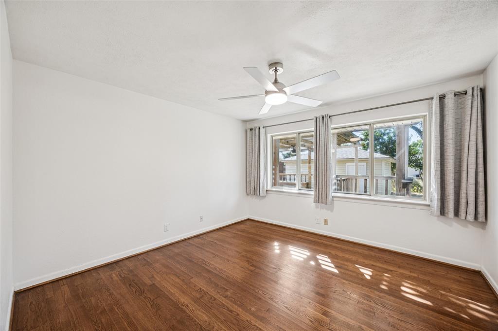 601 Ridgedale Drive Richardson, TX 75080 - Photo 11 of 26 a view of empty room with wooden floor and fan
