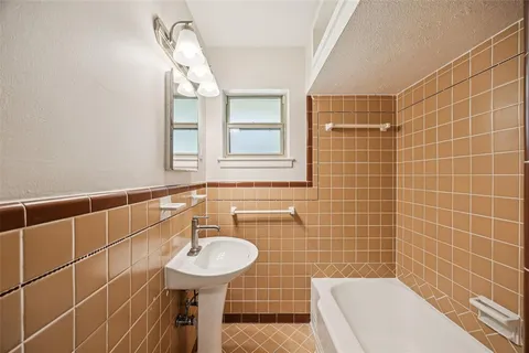 a bathroom with a sink a toilet a mirror and