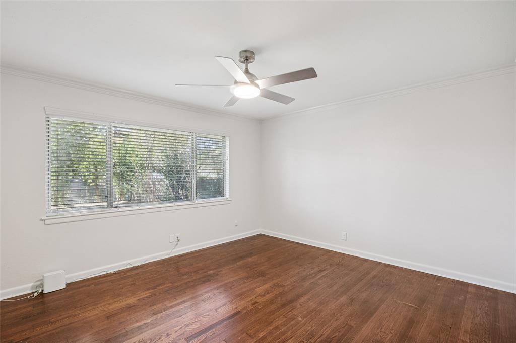 601 Ridgedale Drive Richardson, TX 75080 - Photo 14 of 26 an empty room with wooden floor and windows