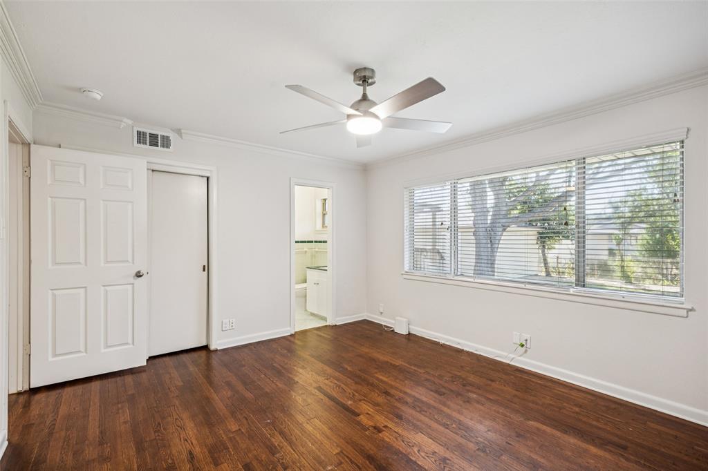 601 Ridgedale Drive Richardson, TX 75080 - Photo 16 of 26 a view of an empty room with a window and wooden floor