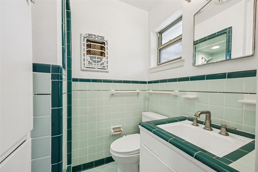 601 Ridgedale Drive Richardson, TX 75080 - Photo 17 of 26 a bathroom with a sink a toilet and mirror