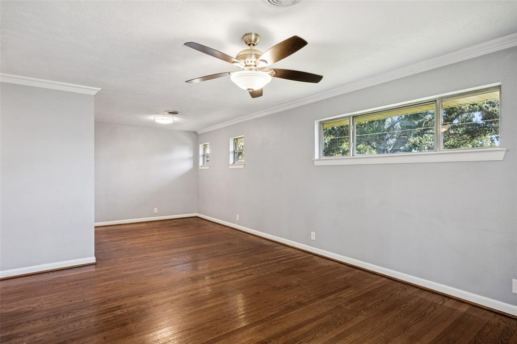 601 Ridgedale Drive Richardson, TX 75080 - Photo 5 of 26 an empty room with wooden floor fan and windows