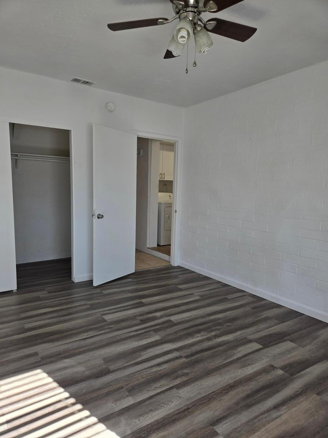 620 East Broadway Lane Tempe, AZ 85282 - Photo 12 of 15 a view of a livingroom with wooden floor and a ceiling fan