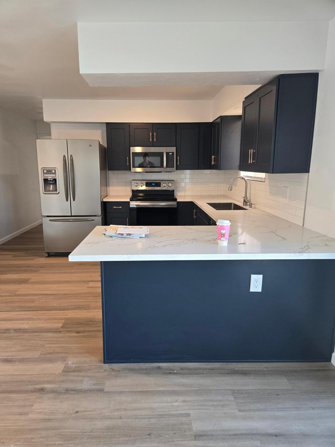620 East Broadway Lane Tempe, AZ 85282 - Photo 3 of 15 a kitchen with stainless steel appliances wooden cabinets and sink