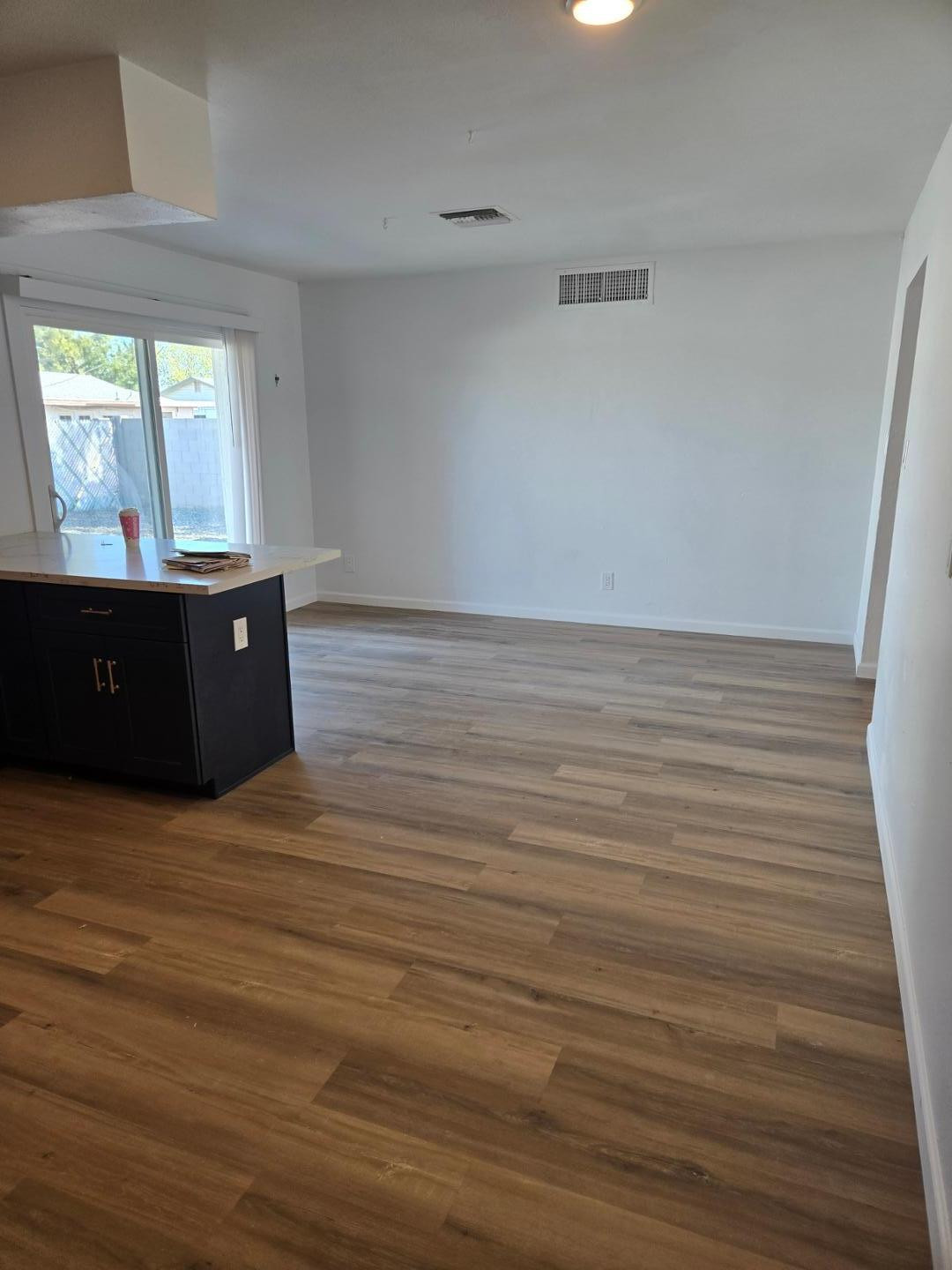 620 East Broadway Lane Tempe, AZ 85282 - Photo 5 of 15 a view of an empty room with wooden floor and a window