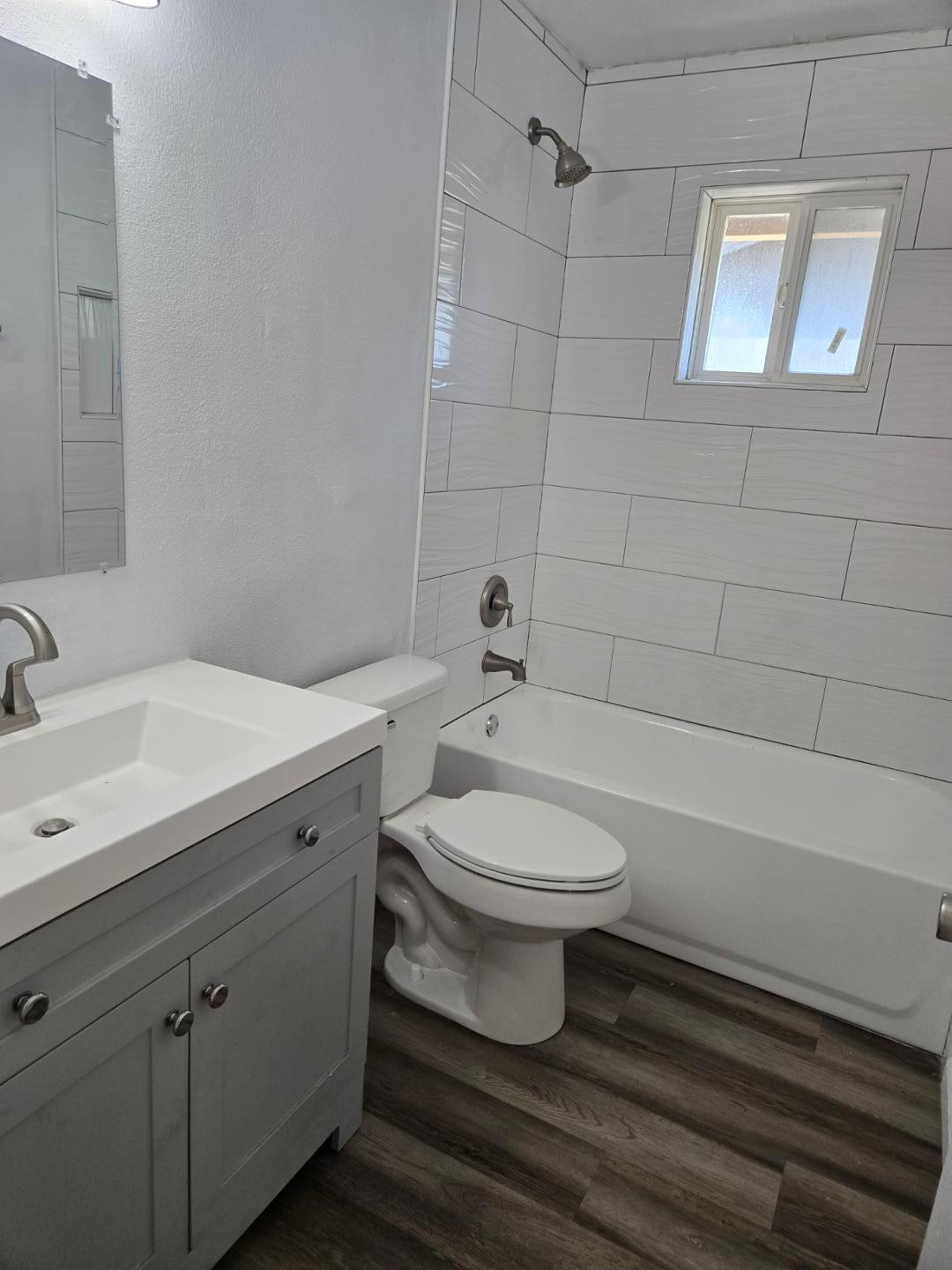 620 East Broadway Lane Tempe, AZ 85282 - Photo 9 of 15 a bathroom with a toilet a sink a mirror and bathtub