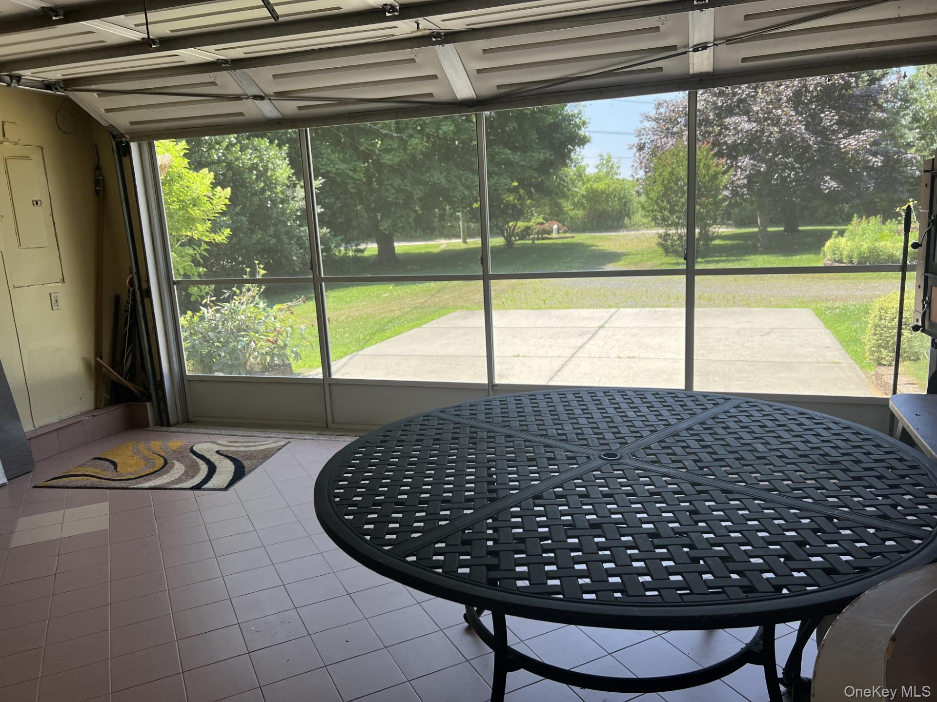 215 Leon Road Southold, NY 11971 - Photo 14 of 17 The Garage converts the space into a cool, casual hangout area for added enjoyment.