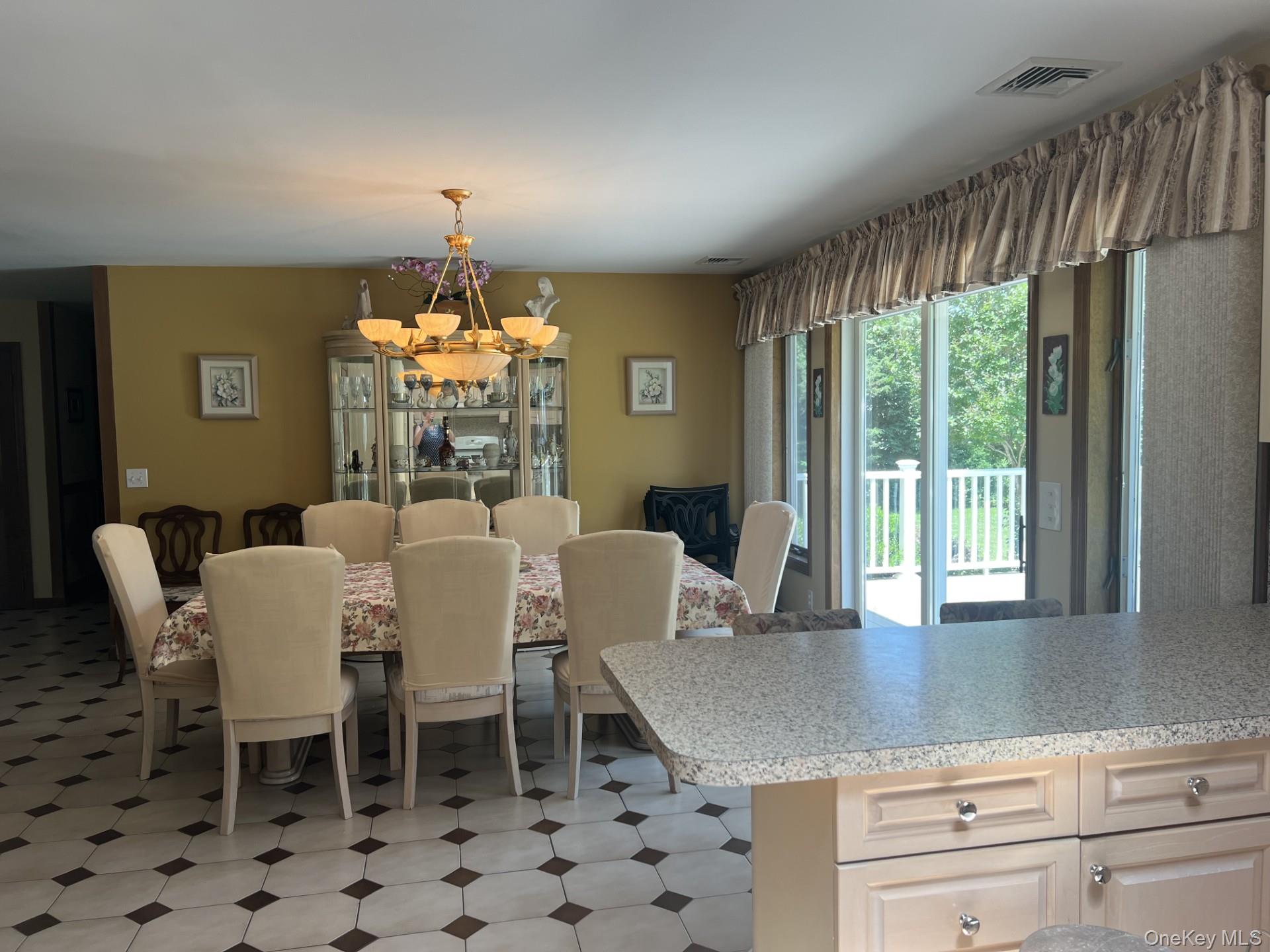 215 Leon Road Southold, NY 11971 - Photo 5 of 17 Dining room with sliding glass doors that lead to a deck.
