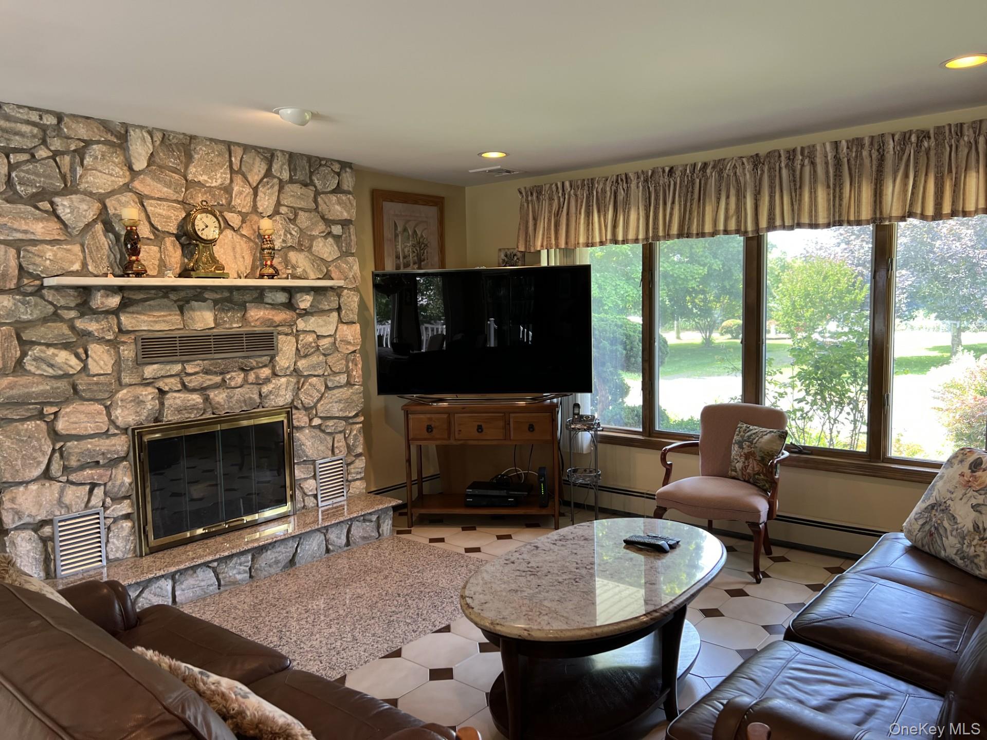 215 Leon Road Southold, NY 11971 - Photo 6 of 17 Lving rooms, where a cozy fireplace adds charm and warmth.
