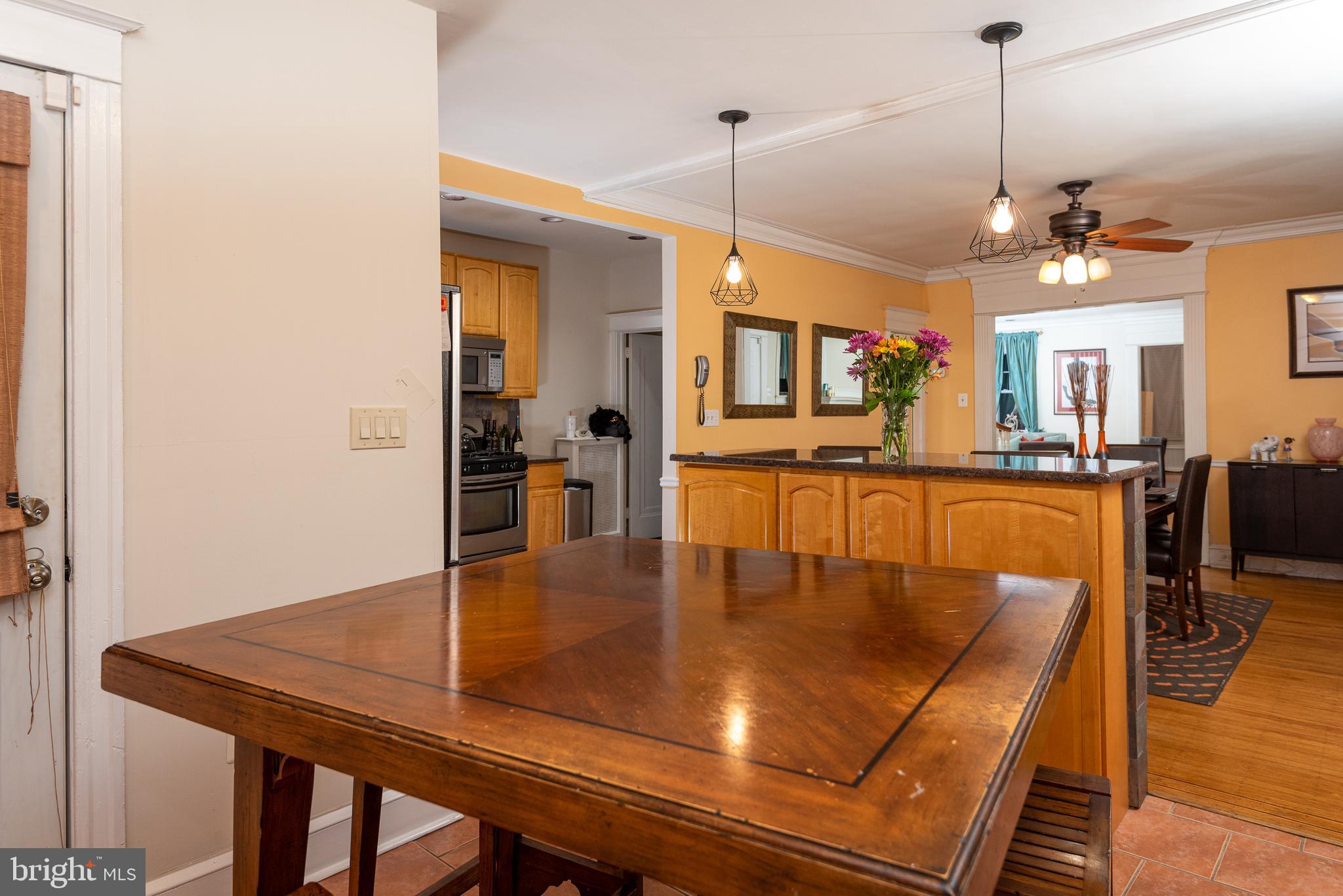 426 Glen Echo Road Philadelphia, PA 19119 - Photo 30 of 77 a dining room with wooden floor a chandelier a wooden table and chairs