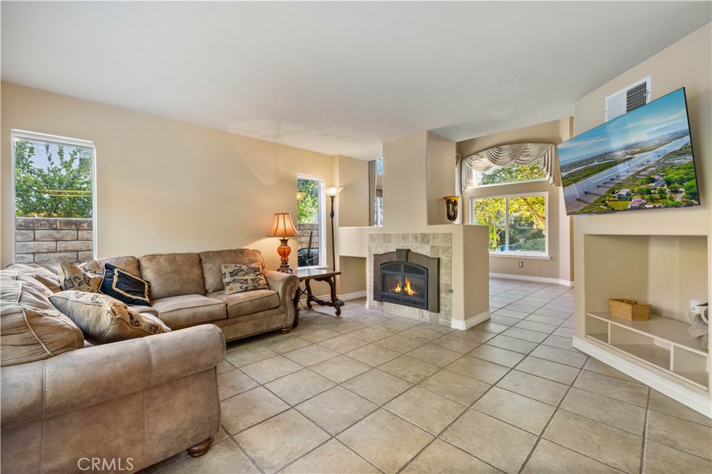 27729 Villa Canyon Road Castaic, CA 91384 - Photo 14 of 72 a living room with furniture and a fireplace
