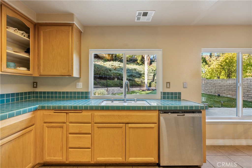 27729 Villa Canyon Road Castaic, CA 91384 - Photo 22 of 72 a kitchen with granite countertop white cabinets and a window