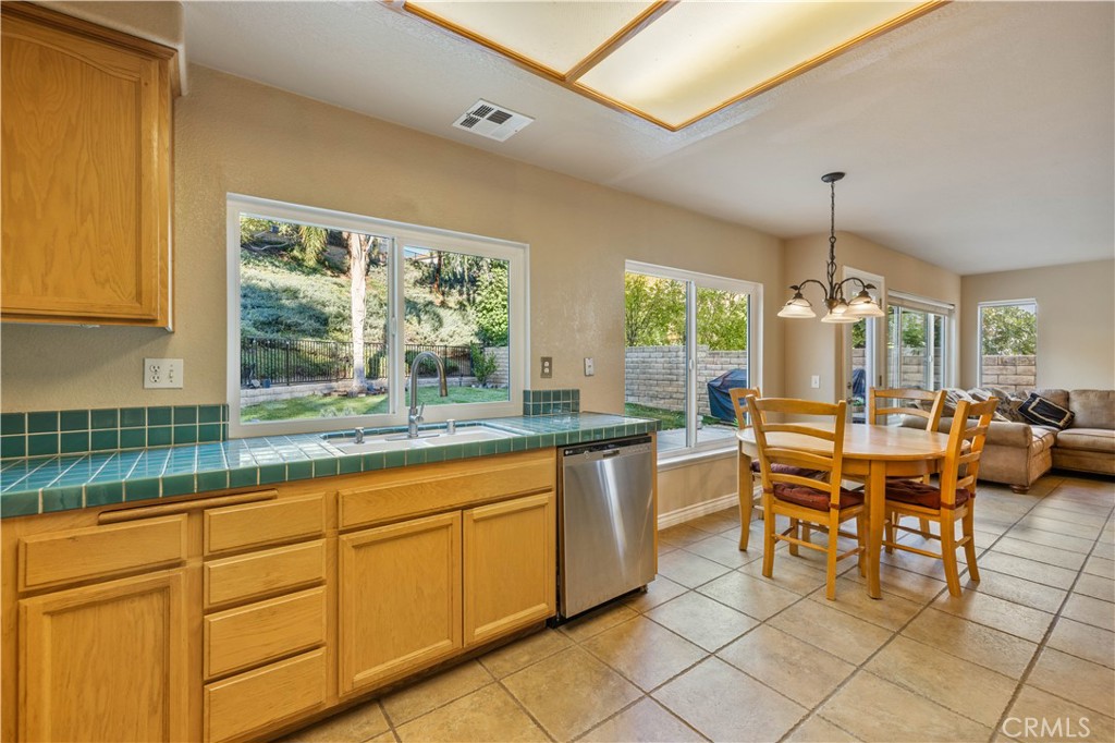 27729 Villa Canyon Road Castaic, CA 91384 - Photo 23 of 72 a dining hall with granite countertop a dining table chairs and white walls