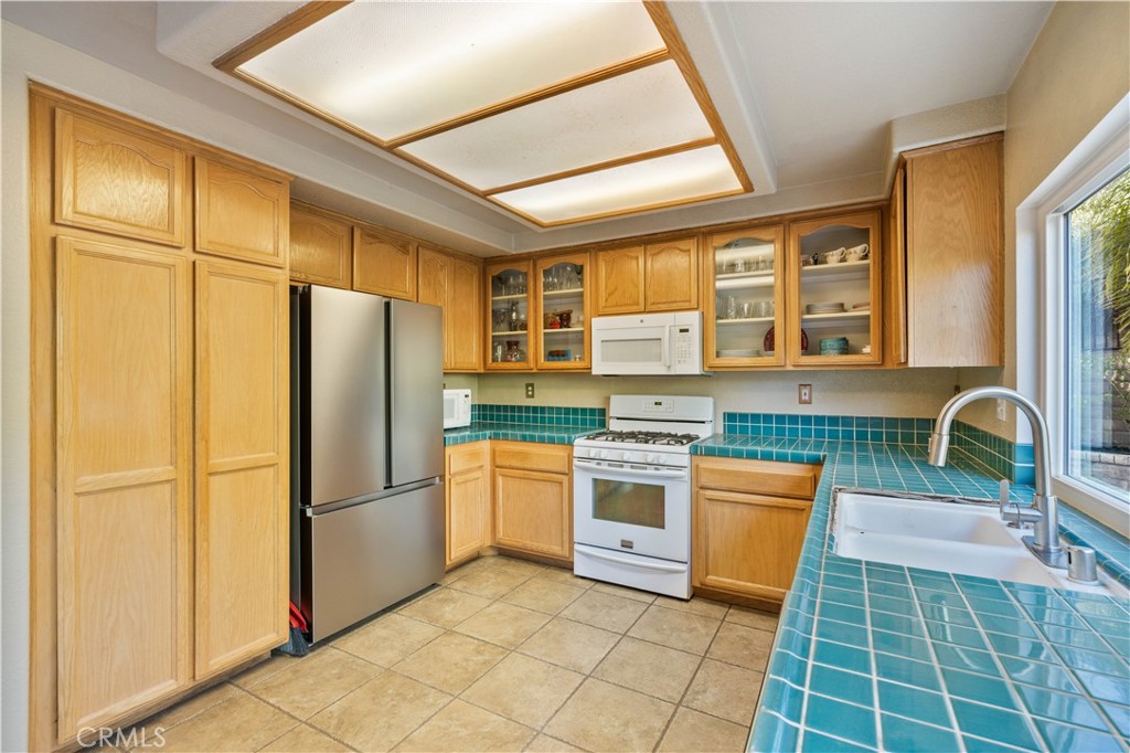 27729 Villa Canyon Road Castaic, CA 91384 - Photo 25 of 72 a kitchen with stainless steel appliances granite countertop a refrigerator a stove a sink and a granite counter tops with a large window