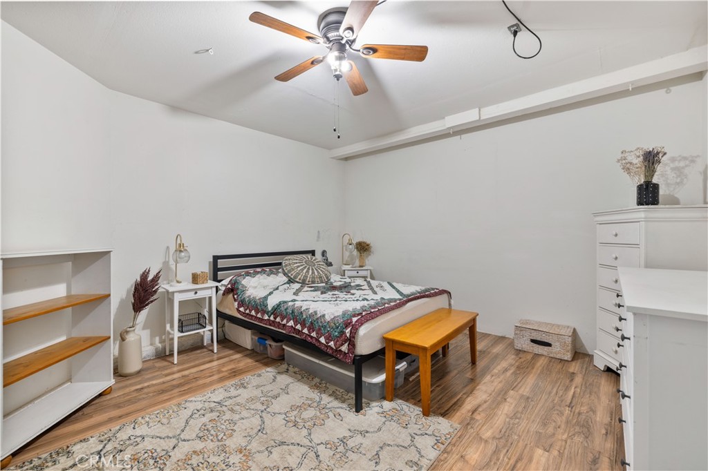 27729 Villa Canyon Road Castaic, CA 91384 - Photo 32 of 72 a spacious bedroom with a bed and a chandelier