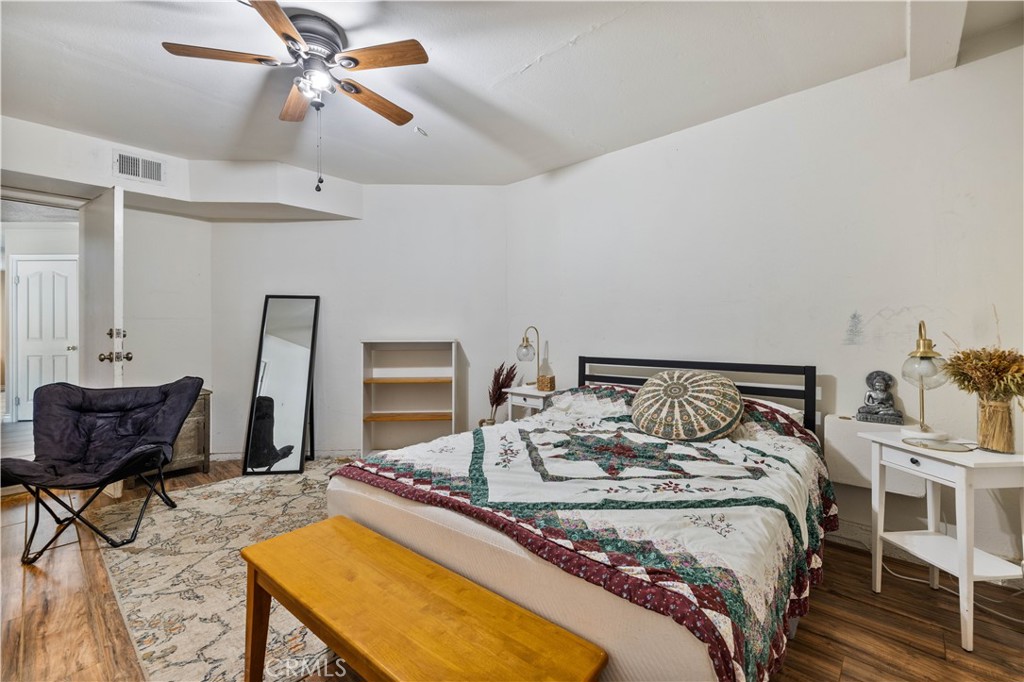 27729 Villa Canyon Road Castaic, CA 91384 - Photo 34 of 72 a bedroom with a bed and a chandelier