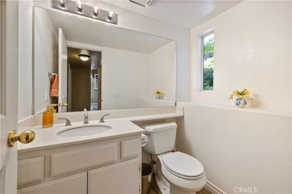 27729 Villa Canyon Road Castaic, CA 91384 - Photo 36 of 72 a bathroom with a sink mirror vanity and toilet