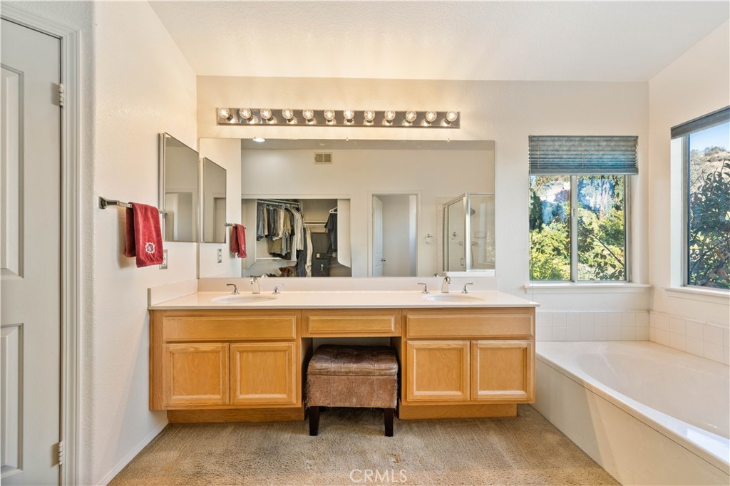 27729 Villa Canyon Road Castaic, CA 91384 - Photo 46 of 72 a spacious bathroom with a large tub sink and mirror