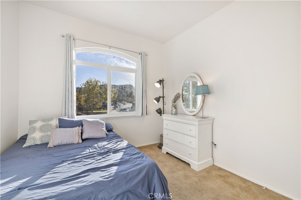 27729 Villa Canyon Road Castaic, CA 91384 - Photo 49 of 72 a bedroom with a bed and window with couch