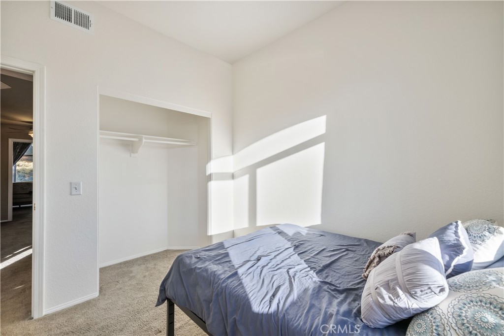 27729 Villa Canyon Road Castaic, CA 91384 - Photo 50 of 72 a bedroom with a bed and a mirror