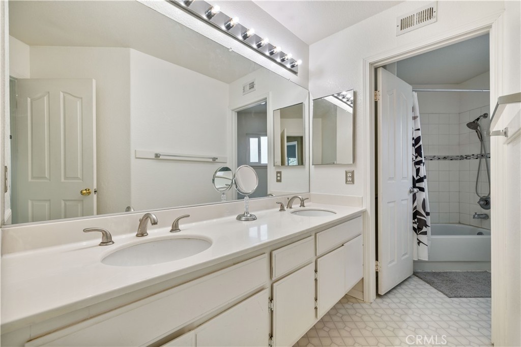 27729 Villa Canyon Road Castaic, CA 91384 - Photo 55 of 72 a bathroom with a double vanity sink mirror and shower