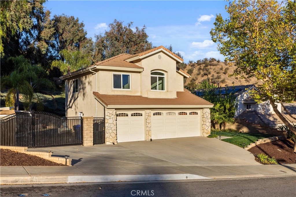 27729 Villa Canyon Road Castaic, CA 91384 - Photo 65 of 72 a front view of a house with a yard and garage