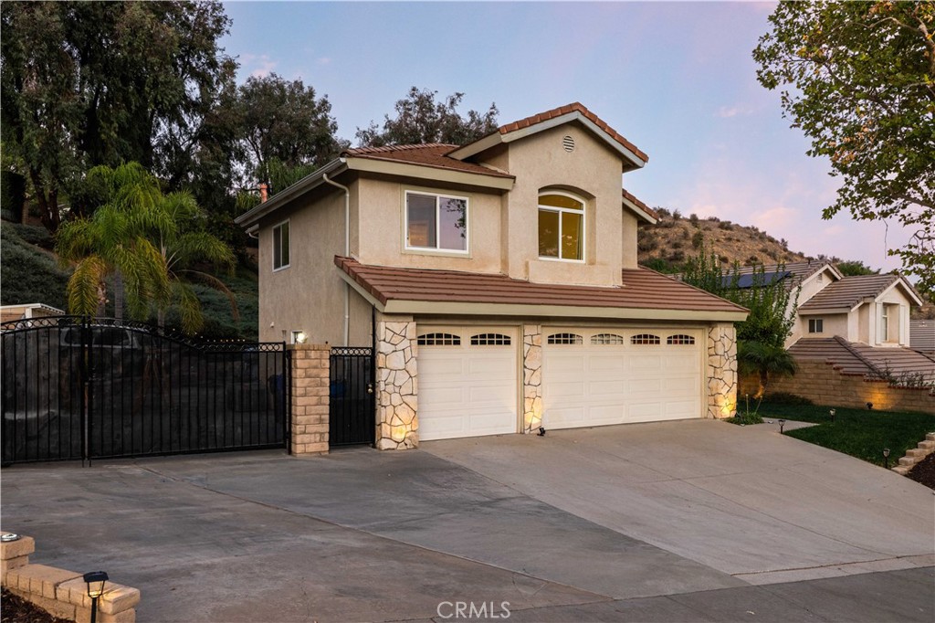 27729 Villa Canyon Road Castaic, CA 91384 - Photo 71 of 72 a front view of a house with a yard and garage