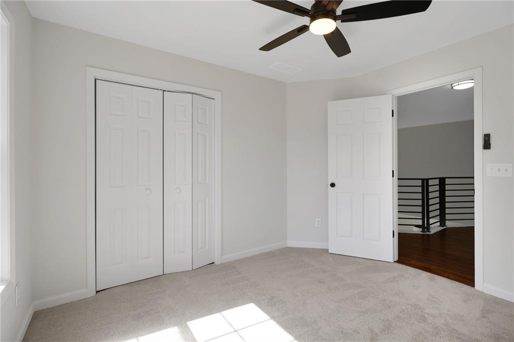 6259 Spring Lake Drive Flowery Branch, GA 30542 - Photo 12 of 35 a view of an empty room with a ceiling fan