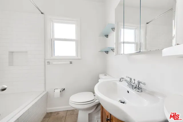 a view of bathroom with a toilet a sink and a closet