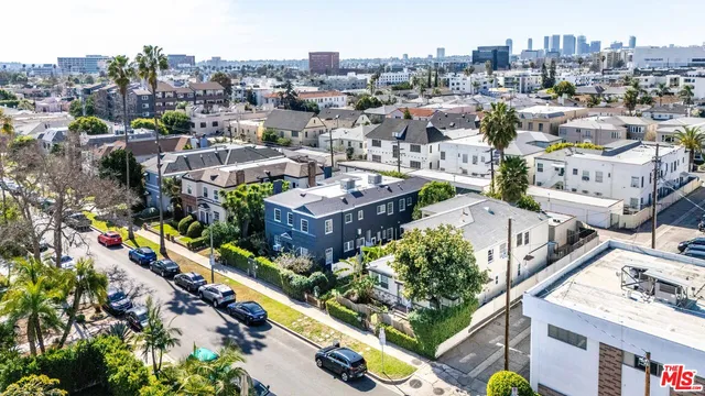 an aerial view of residential houses with city view