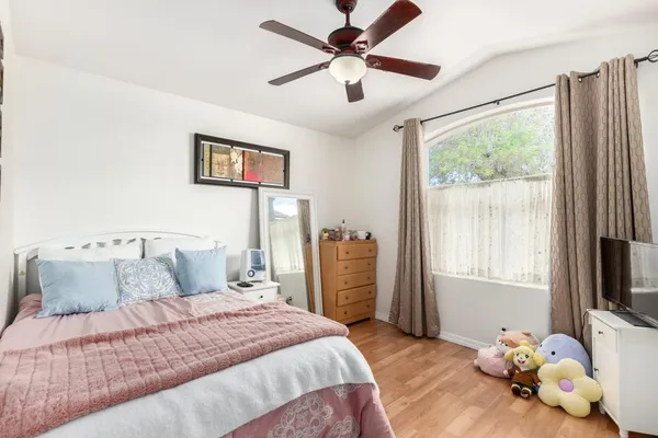 a bedroom with a bed and a window