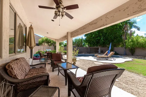 a living room with patio furniture and a wooden floor