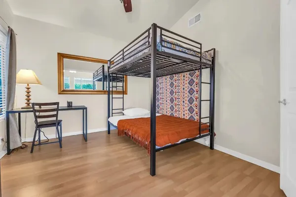 a bedroom with a bed and a chandelier