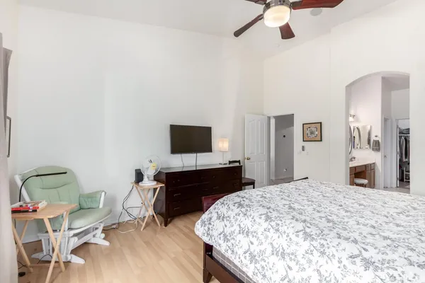 a bedroom with a bed and a flat screen tv