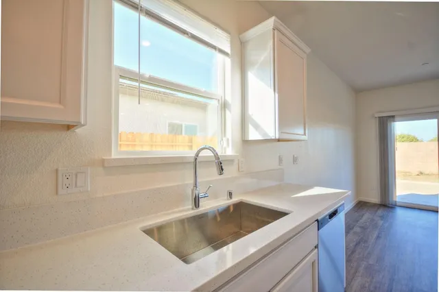 a kitchen with a sink a counter top space and a window