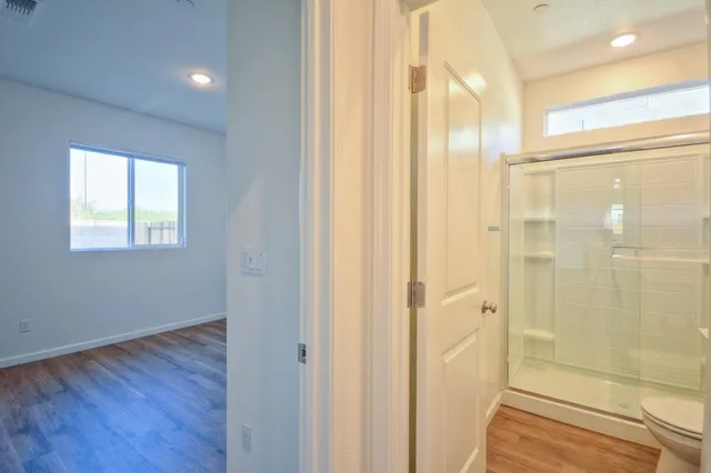 a bathroom with a glass shower door and a bathroom